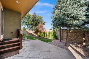 Fenced backyard featuring a patio