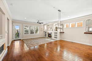 Unfurnished living room with a fireplace, hardwood floors, and dining area