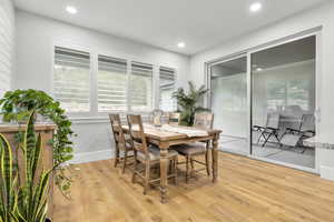 Dining area with healthy amount of natural light, light wood-type flooring, and recessed lighting