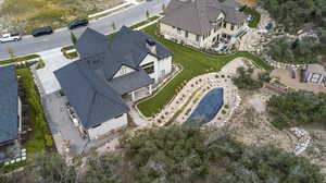 Aerial view of property and surrounding area with a pool area