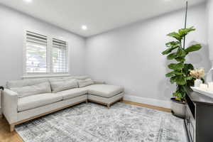 Living area with wood finished floors and recessed lighting