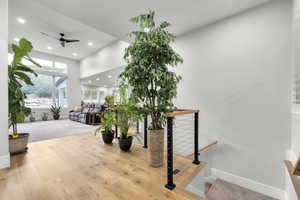 Interior space with wood finished floors, ceiling fan, and recessed lighting