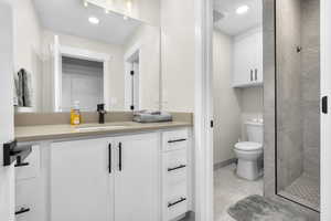 Bathroom with vanity, a stall shower, recessed lighting, and tile patterned flooring