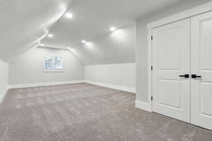 Additional living space with carpet, recessed lighting, and vaulted ceiling