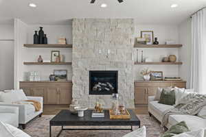 Living area with recessed lighting, ceiling fan, and a fireplace