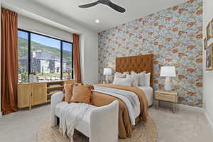 Bedroom featuring wallpapered walls, light colored carpet, an accent wall, a ceiling fan, and recessed lighting