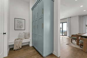 Corridor featuring wood finished floors and recessed lighting