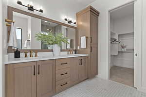 Full bath featuring double vanity and a walk in closet