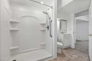Bathroom featuring a stall shower and vanity