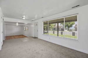 Carpeted spare room with baseboards