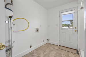 Laundry area featuring hookup for an electric dryer, water heater, and washer hookup