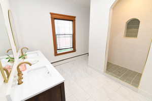 Full bathroom featuring a baseboard heating unit and a stall shower
