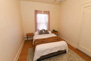 Bedroom featuring light wood finished floors and baseboard heating
