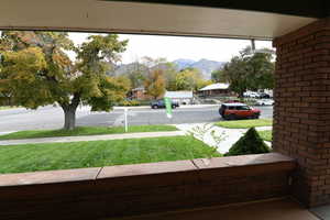 View of grassy yard with a mountain view