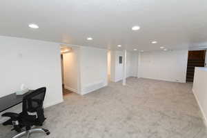 Unfurnished office featuring light colored carpet and recessed lighting