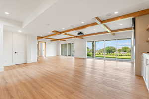 Unfurnished living room with beamed ceiling, recessed lighting, light wood-style floors, and coffered ceiling