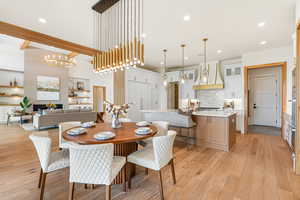 Dining room featuring light wood-style flooring, a chandelier, and recessed lighting