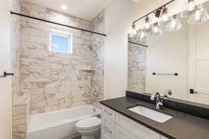 Full bathroom featuring vanity and washtub / shower combination