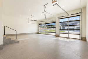 Garage featuring a garage door opener and recessed lighting