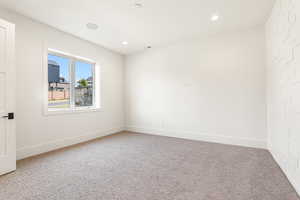 Unfurnished room with carpet floors and recessed lighting