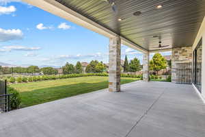 View of patio / terrace featuring a ceiling fan and a mountain view