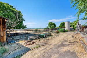 View of yard featuring an exterior structure, a rural view, and an outdoor structure