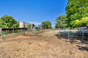 View of yard featuring an exterior structure, a view of rural / pastoral area, and an outdoor structure