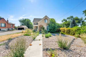 View of front of home with an outbuilding and brick siding
