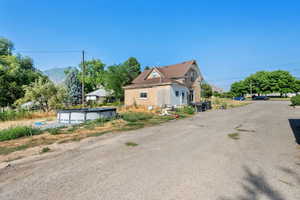 View of property exterior with a covered pool