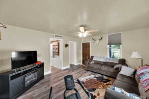 Living room featuring wood finished floors and ceiling fan