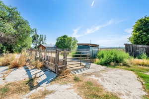 Gate featuring an exterior structure, an outbuilding, and a view of rural / pastoral area