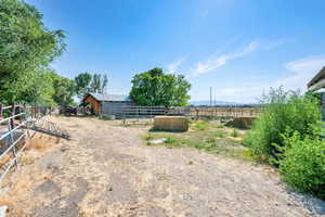 View of yard featuring an exterior structure, a view of rural / pastoral area, and an outdoor structure