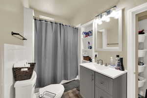 Bathroom featuring vanity, wood finished floors, and a shower with shower curtain
