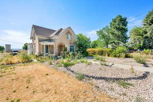 View of front of home with brick siding and a shingled roof