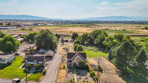 Aerial view of property and surrounding area with a mountainous background