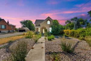 View of front facade with an outdoor structure and brick siding