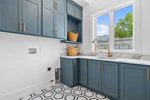Washroom featuring cabinet space, electric dryer hookup, and hookup for a washing machine