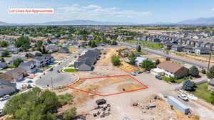 Aerial view of residential area featuring property parcel outlined and mountains