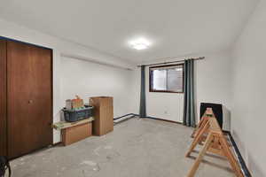 Bedroom featuring a textured ceiling and unfinished concrete floors