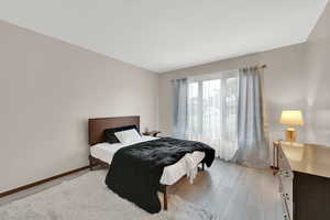 Bedroom featuring light wood-style floors and baseboards