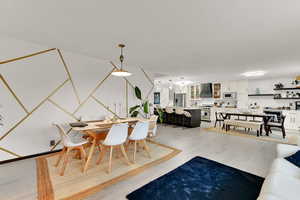 Dining area with light wood-style flooring