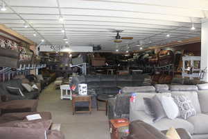 Living area featuring track lighting and a ceiling fan
