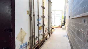 Hall with unfinished concrete floors and concrete block wall