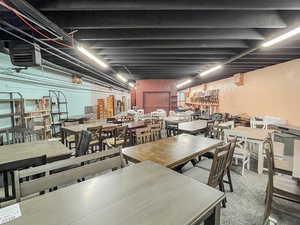 Carpeted dining space featuring a heating unit