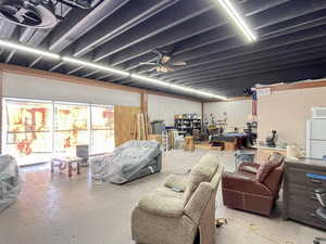 Basement featuring freestanding refrigerator and a ceiling fan