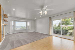 Spare room with a ceiling fan, wood finished floors, carpet flooring, recessed lighting, and a textured ceiling