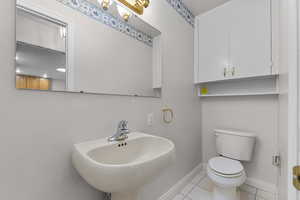 Bathroom with toilet and tile patterned floors