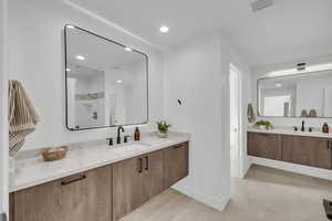 Full bath featuring vanity, recessed lighting, and a shower