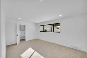 Empty room with carpet floors and recessed lighting