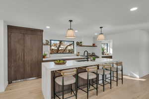 Kitchen with open shelves, light countertops, plenty of natural light, and recessed lighting